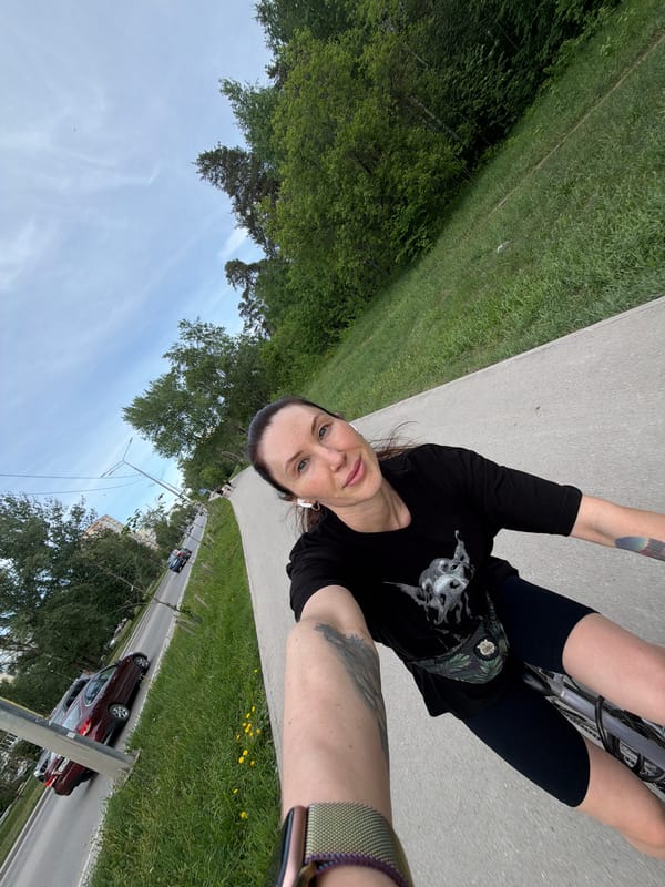 Woman takes cycling selfies on park path in Perm