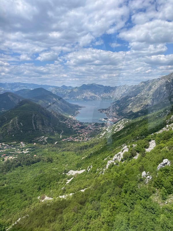 Elevated view captures Škaljari's bay and mountain landscape