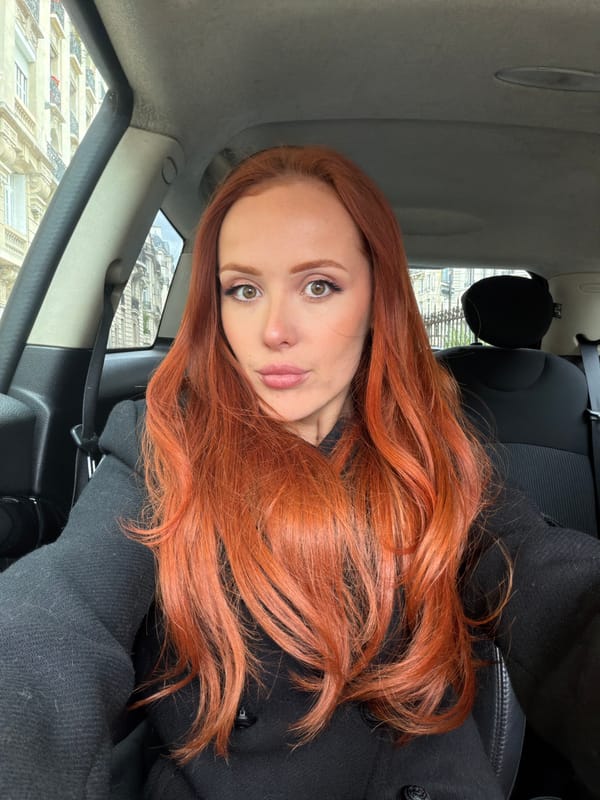 Red-haired woman in black coat spotted driving in Paris