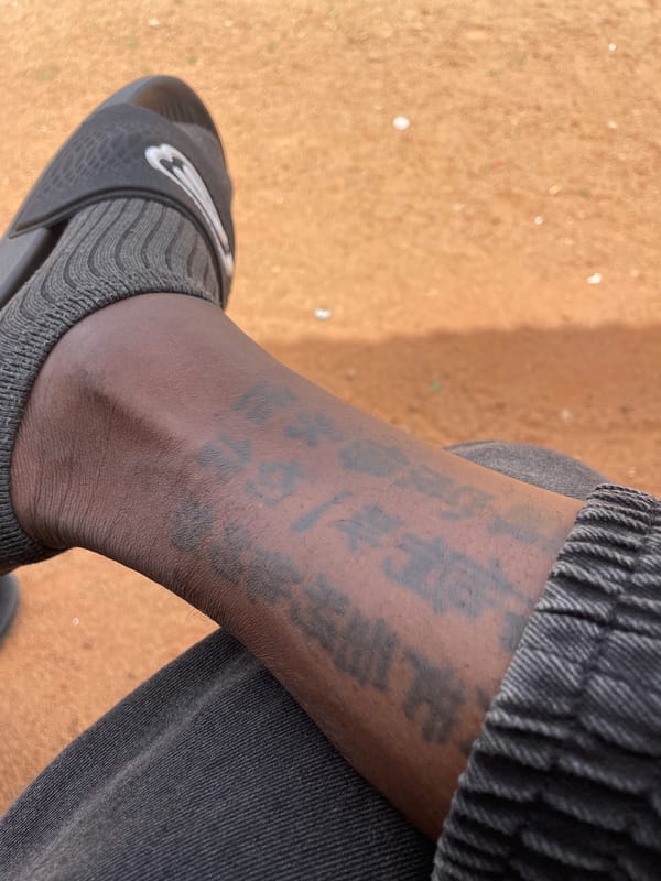 Person in sports attire spotted seated outdoors in Jos