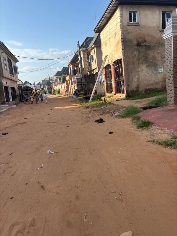 Everyday life on a dusty residential street in Obosi, Nigeria