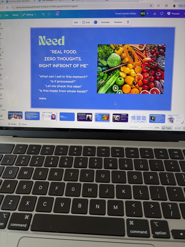Person works on Canva presentation using MacBook in Austin workspace