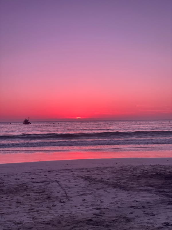 Sunset observed over Iquique coast with fishing boat present
