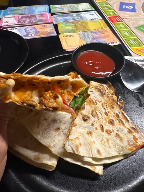 Board game session with Indonesian currency documented in Kuta Selatan