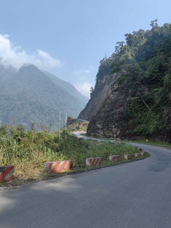 Mountain road with striped barriers documented in Vietnam
