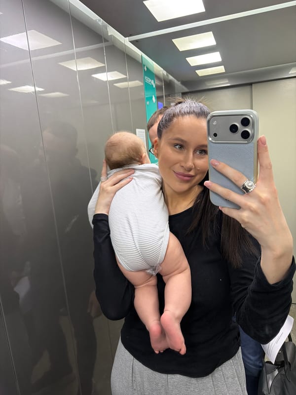 Woman takes mirror selfie with baby in Moscow
