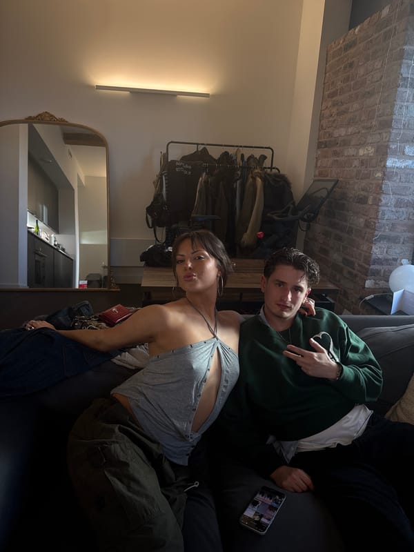 Two people photographed on sofa in Manchester home