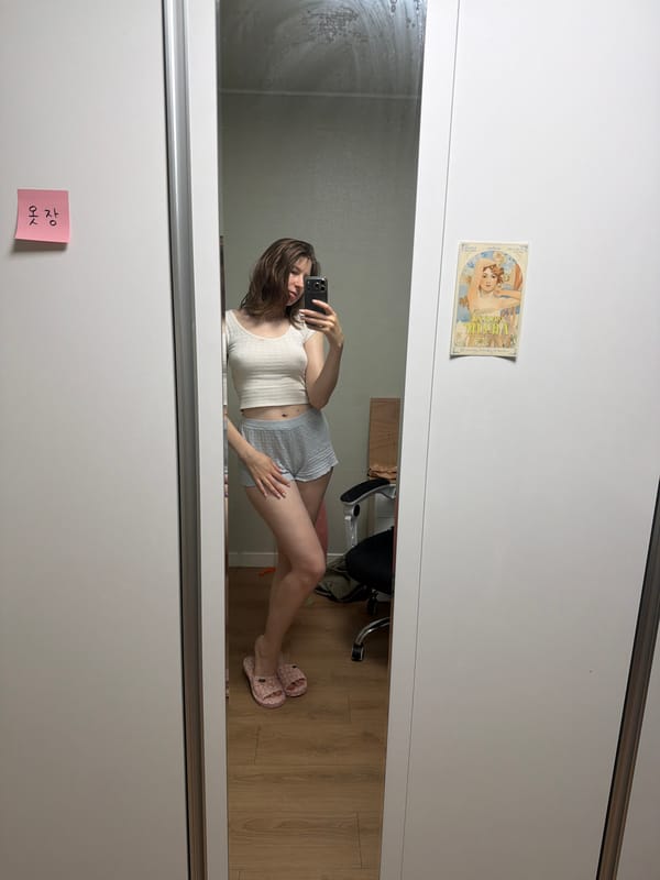 Indoor selfie session in Dongducheon-si with an Alphonse Mucha postcard