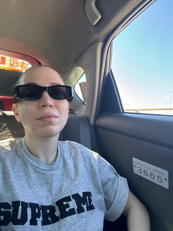 Woman in sunglasses spotted in car with identification plate
