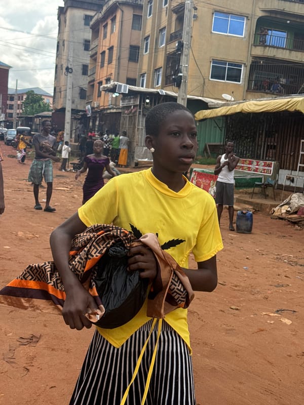 Morning street life along a muddy road in Onitsha