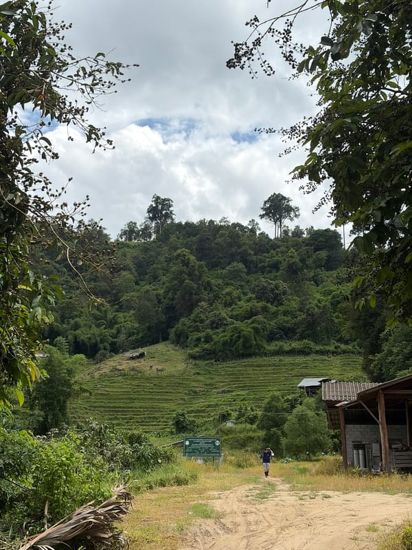 Quiet rural stop in Mae Win, Thailand — paths, pond, and a red scooter