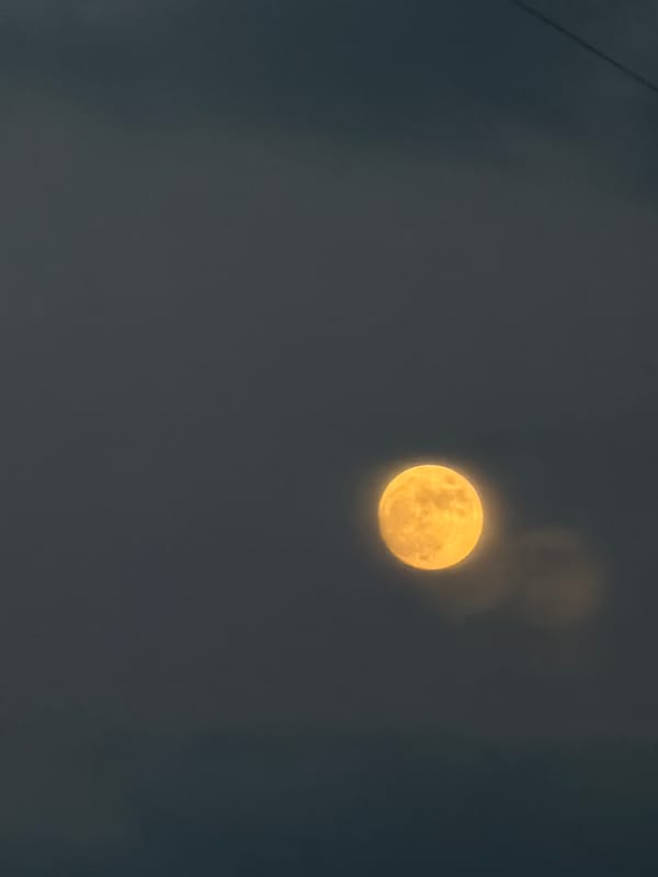 Full moon observed in hazy evening sky over Michurinsk