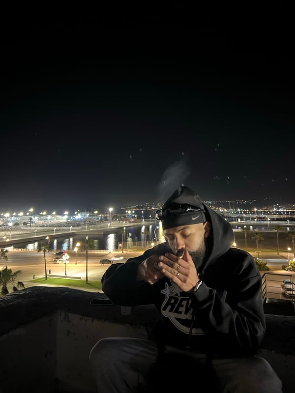 Man sits overlooking Tangier port at night