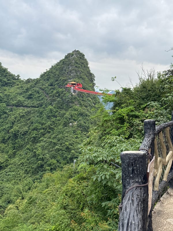 Elevated red walkway winds through Guilin's forested mountains