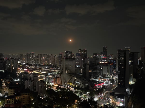 Full moon illuminates Mexico City skyline at night