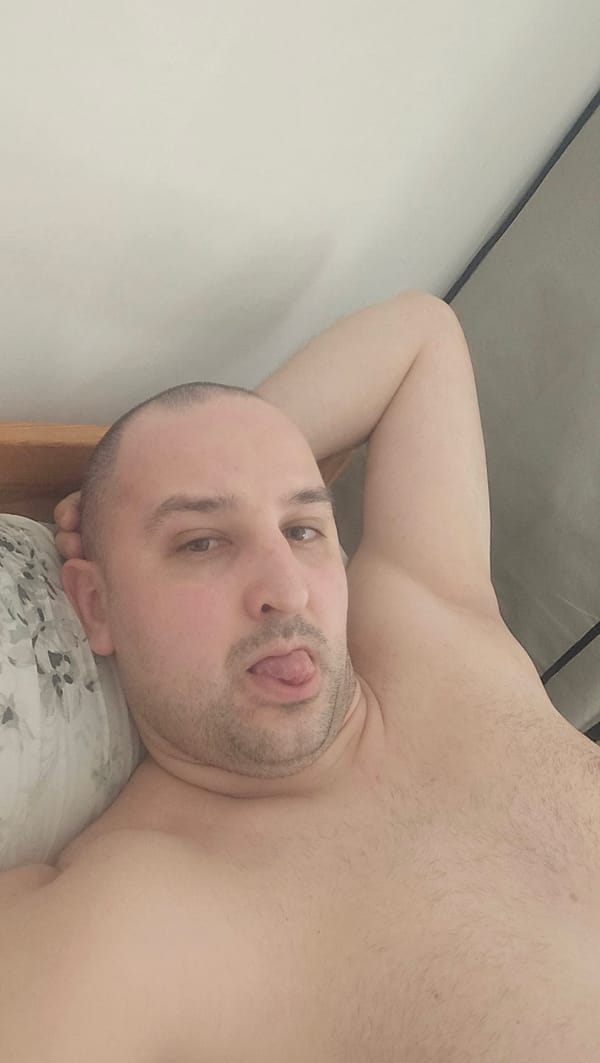 Man rests playfully on pillow in Crimmitschau