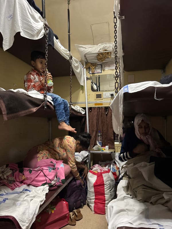 Boy drinks from cup on Indian Railways train near Ambernath