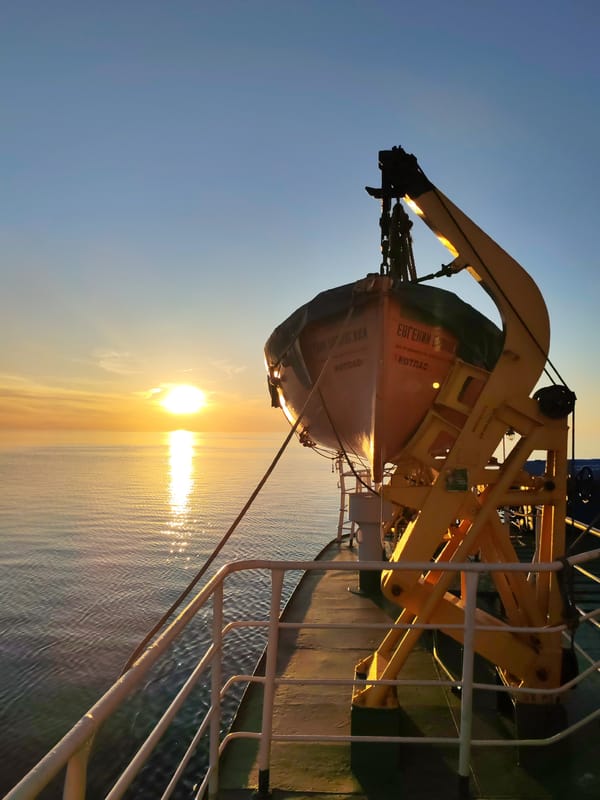 Maritime sunset documented by shipboard witnesses at sea