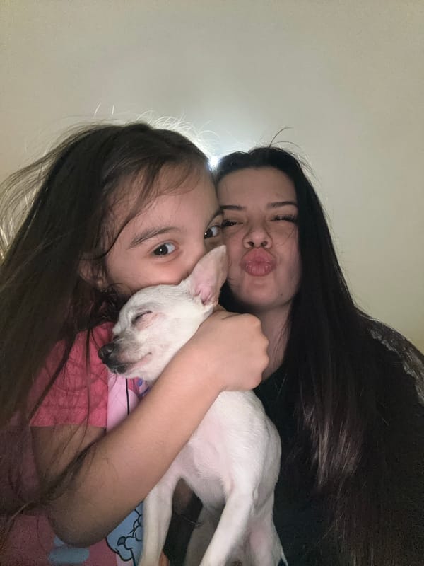 Woman and child pose with white dog in Bulgaria