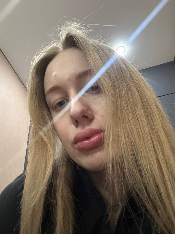 Woman takes multiple selfies indoors in Azov, Russia