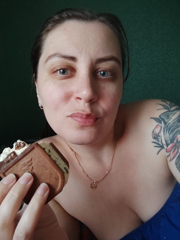 Grey cat crashes an ice cream and cherry snack session