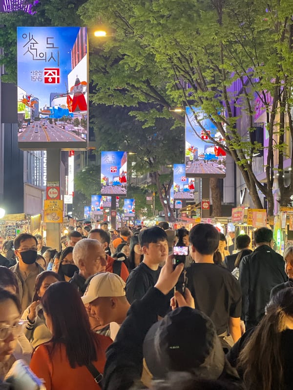 Dense crowds fill Seoul street during daytime hours