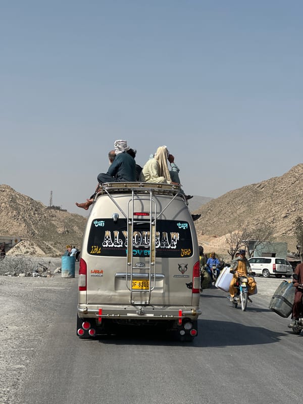 Overloaded van carries roof passengers in Quetta, Pakistan
