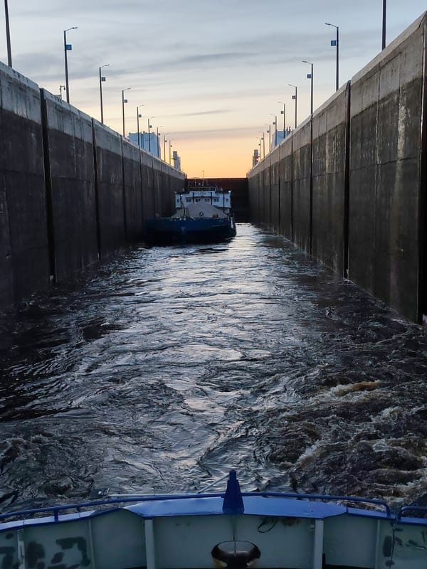 Cargo barges transit Volga-Baltic Waterway lock in Sheksna, Russia