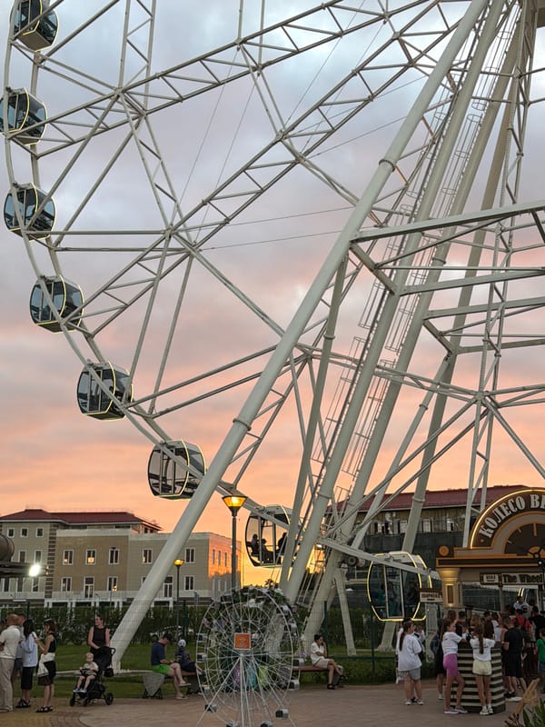 Ferris wheel and festive balloon at Sirius amusement area