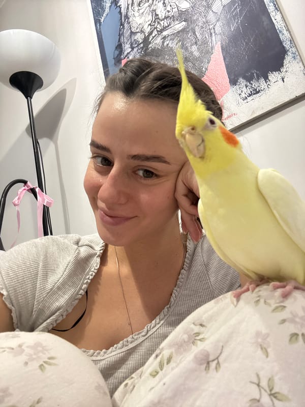 Woman and yellow cockatiel share intimate moments in Krasnoyarsk home