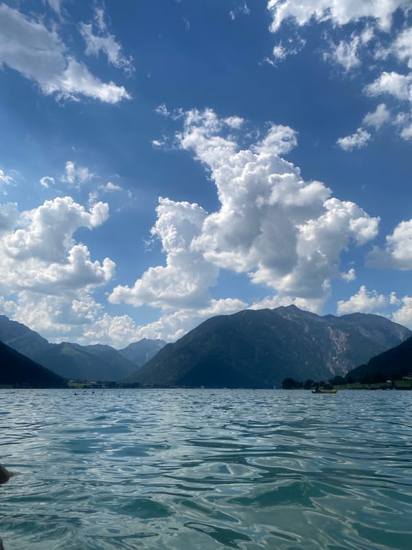 Paddleboarding an Austrian alpine lake on a sunny June day