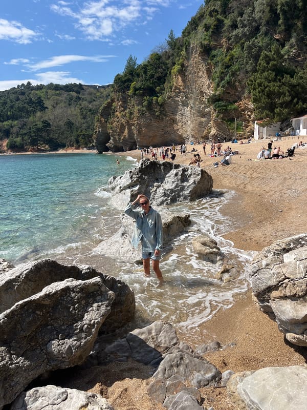 Woman relaxes in water at Pržno beach, Montenegro