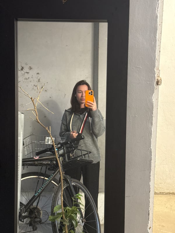 Woman takes early morning selfie near decorated bicycle in Tel Aviv