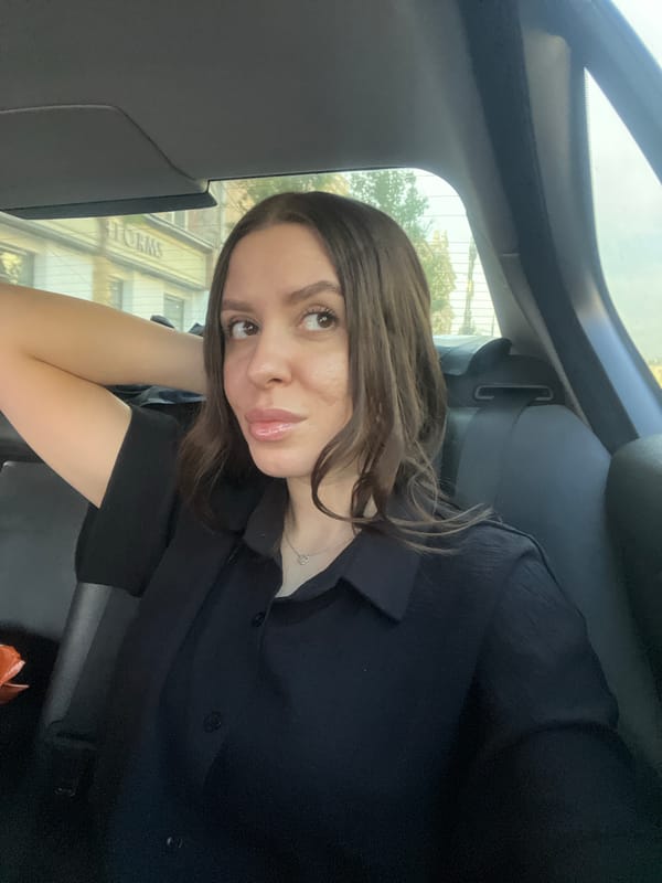 Woman in black shirt observed in car backseat, Moscow