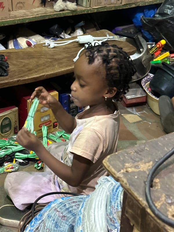 Sitting among clutter in a Narayi market or storage space