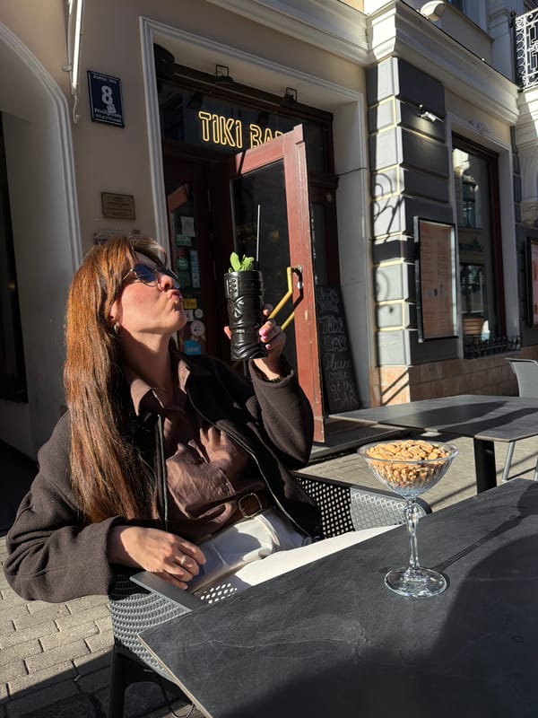 Woman enjoys tropical cocktails at Riga tiki bar afternoon
