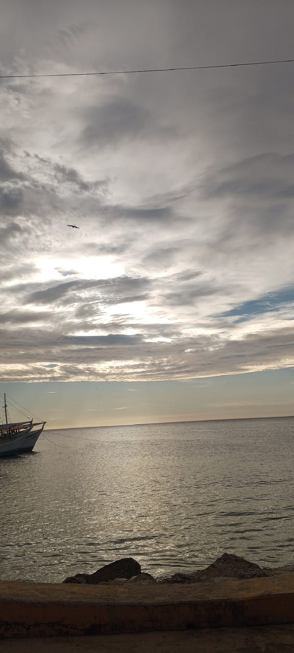 Juan Griego harbor at dusk, clouds and calm water