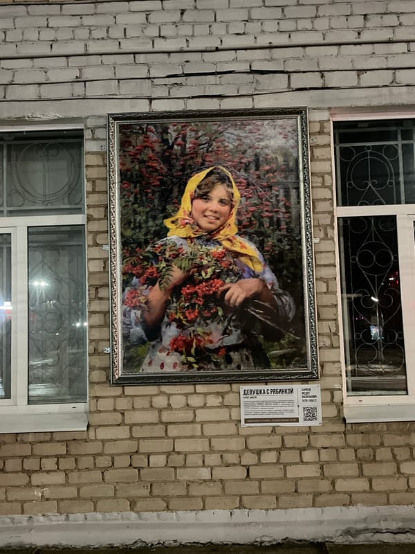 Woman sits at table near heart-decorated window