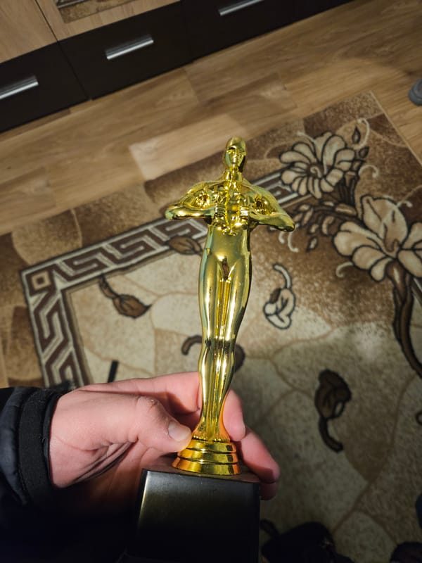 Award statuette and eye artwork photographed in Bulgarian home