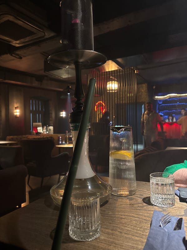 Hookah lounge interior in Kazan with books, busts, and food