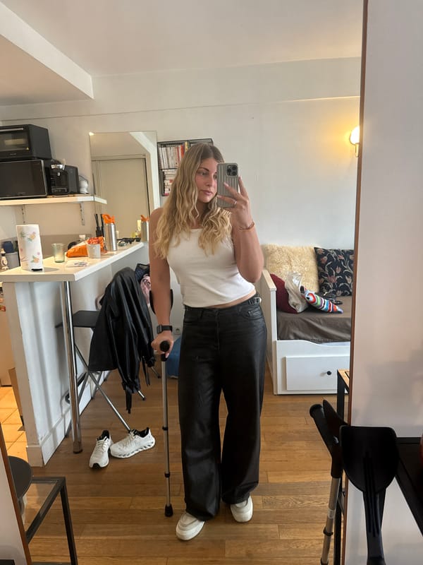 Blonde woman takes multiple selfies in Paris apartment