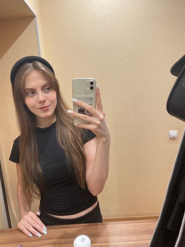 Woman takes multiple selfies in Ufa bedroom