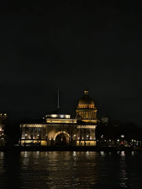 St. Isaac's Cathedral illuminated at night, reflected in waters