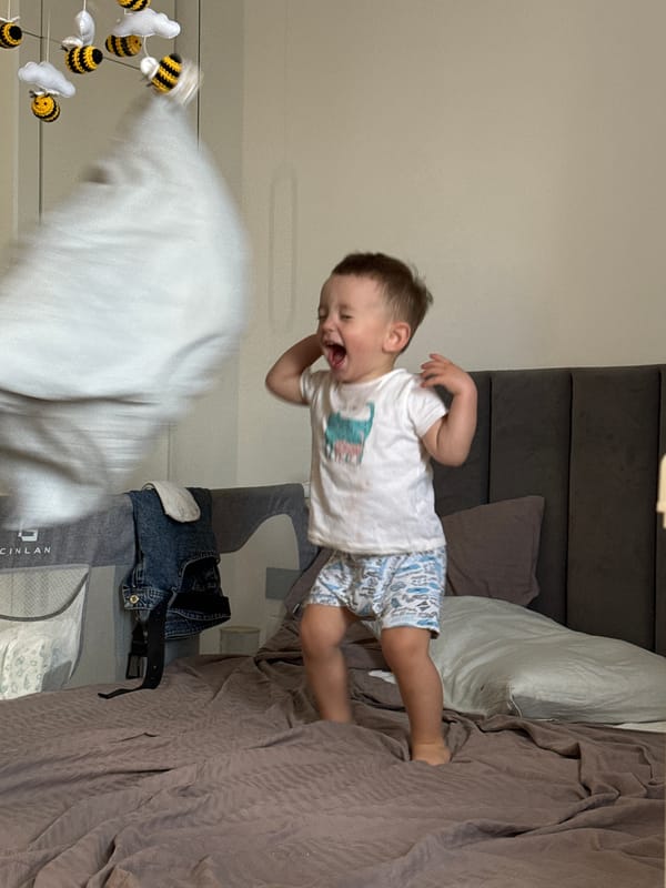 Toddler jumps on bed in Odintsovo bedroom