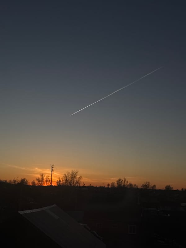 Sunset documented with contrail over Фоки, Russia