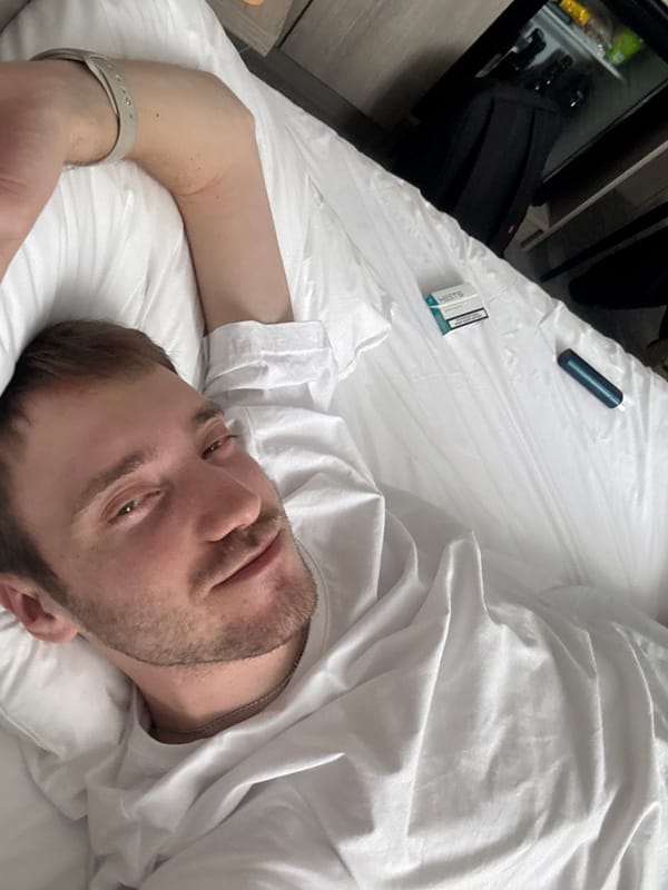 Man rests in bed with personal items in Russia