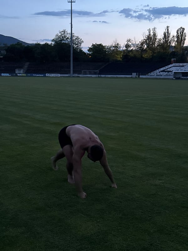 Lone athlete performs acrobatics on empty stadium field