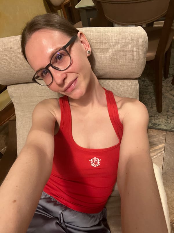 Person in red tank top rests on chair in Khimki