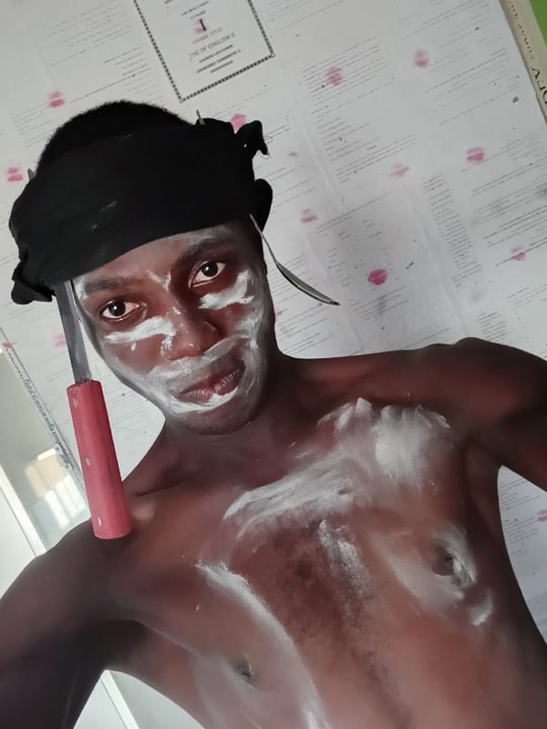 Man in black head wrap performs with kitchen utensils