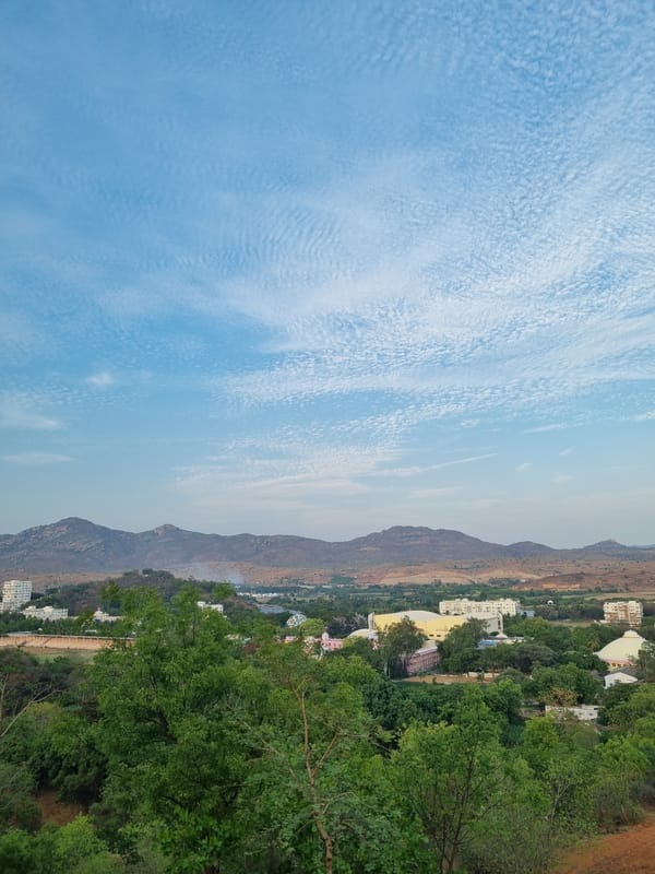Elevated daytime view of clouds and mountains in Puttaparthi